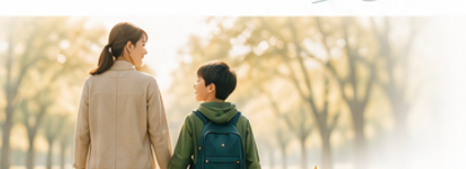 紅葉の並木道を、手をつないで歩く保護者とお子さまの後ろ姿
